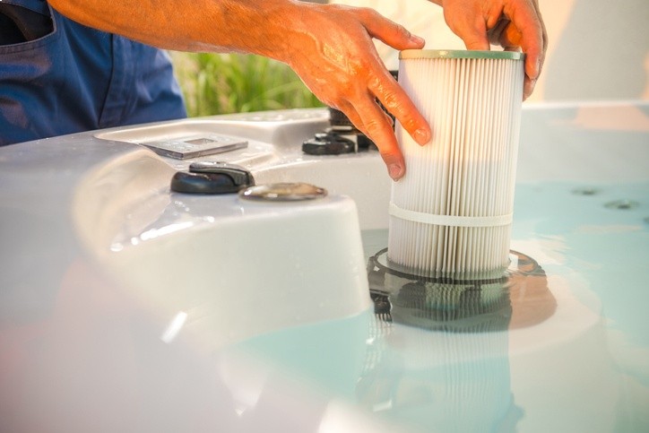 man changing hot tub filters